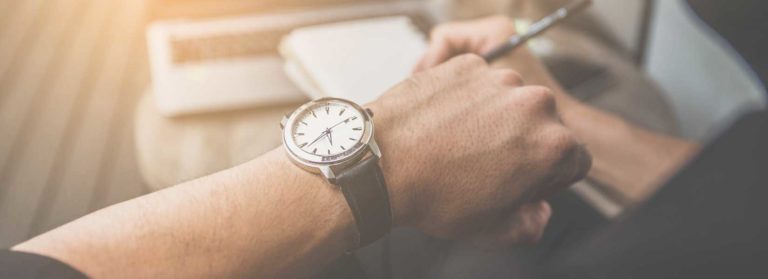Person looking at clock wondering how long he should wait before contacting a car accident lawyer